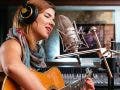 girl singing with guitar recording studio