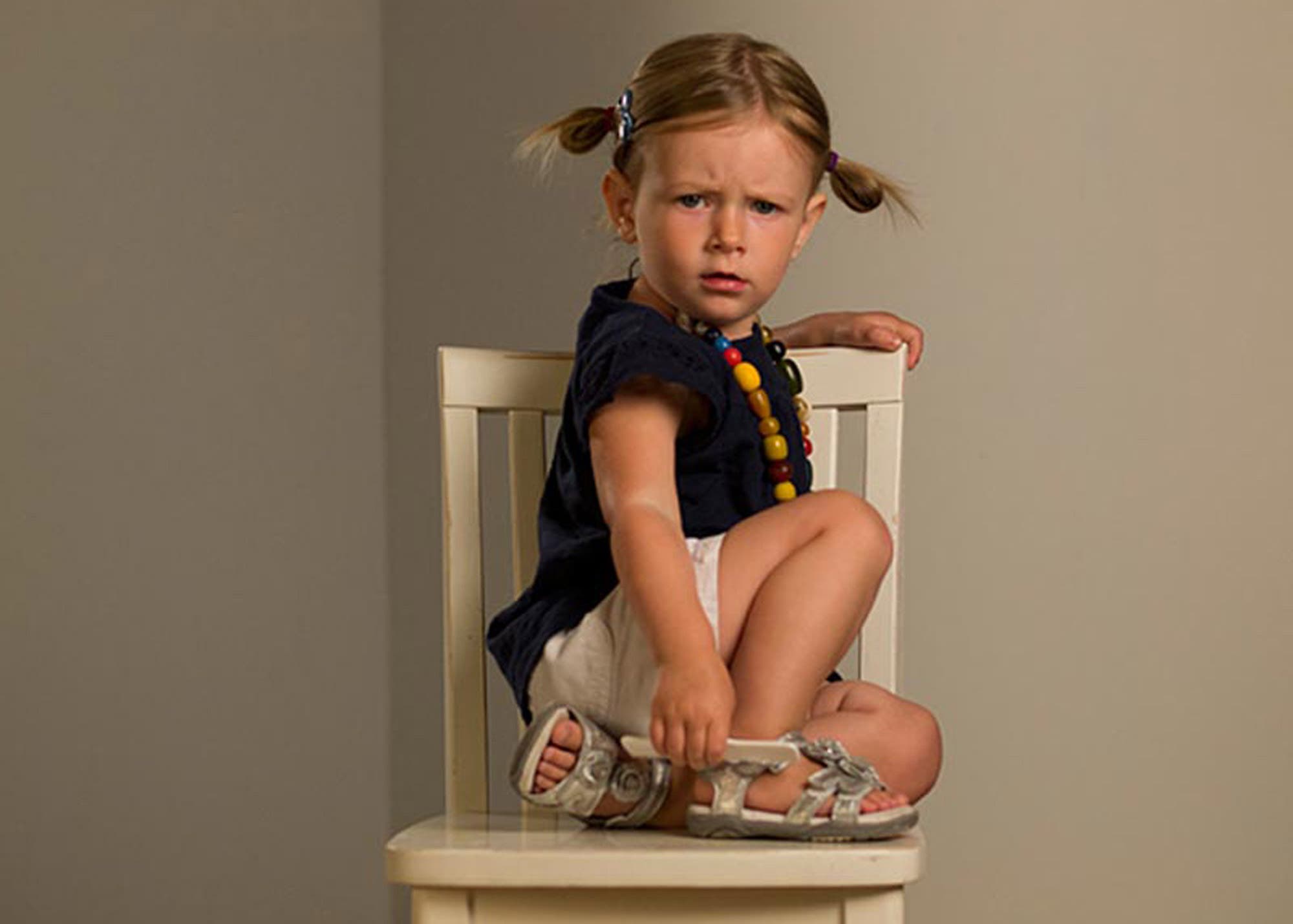 girl sitting on chair