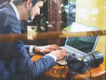 man laptop dlsr camera