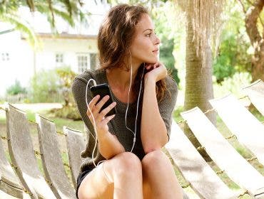 girl listening earphones hammock