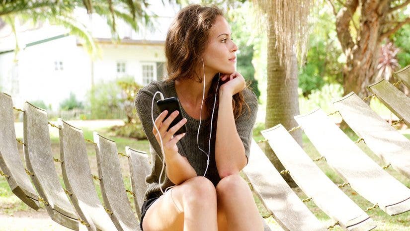 girl listening earphones hammock