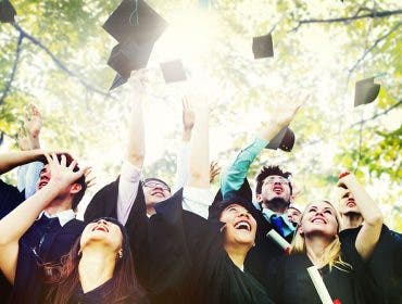 graduation students throwing caps