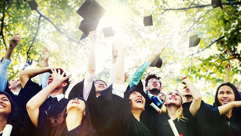 graduation students throwing caps