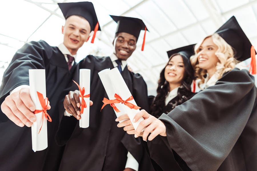 graduated students showing diplomas
