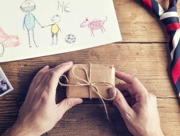 present and tie laid on wooden desk backround