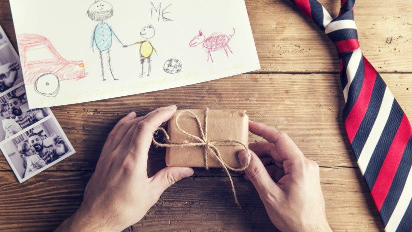 present and tie laid on wooden desk backround