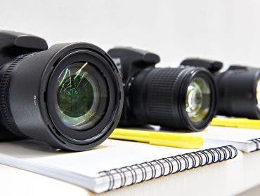 dslr cameras on notepads