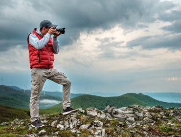 Man photographing landscape