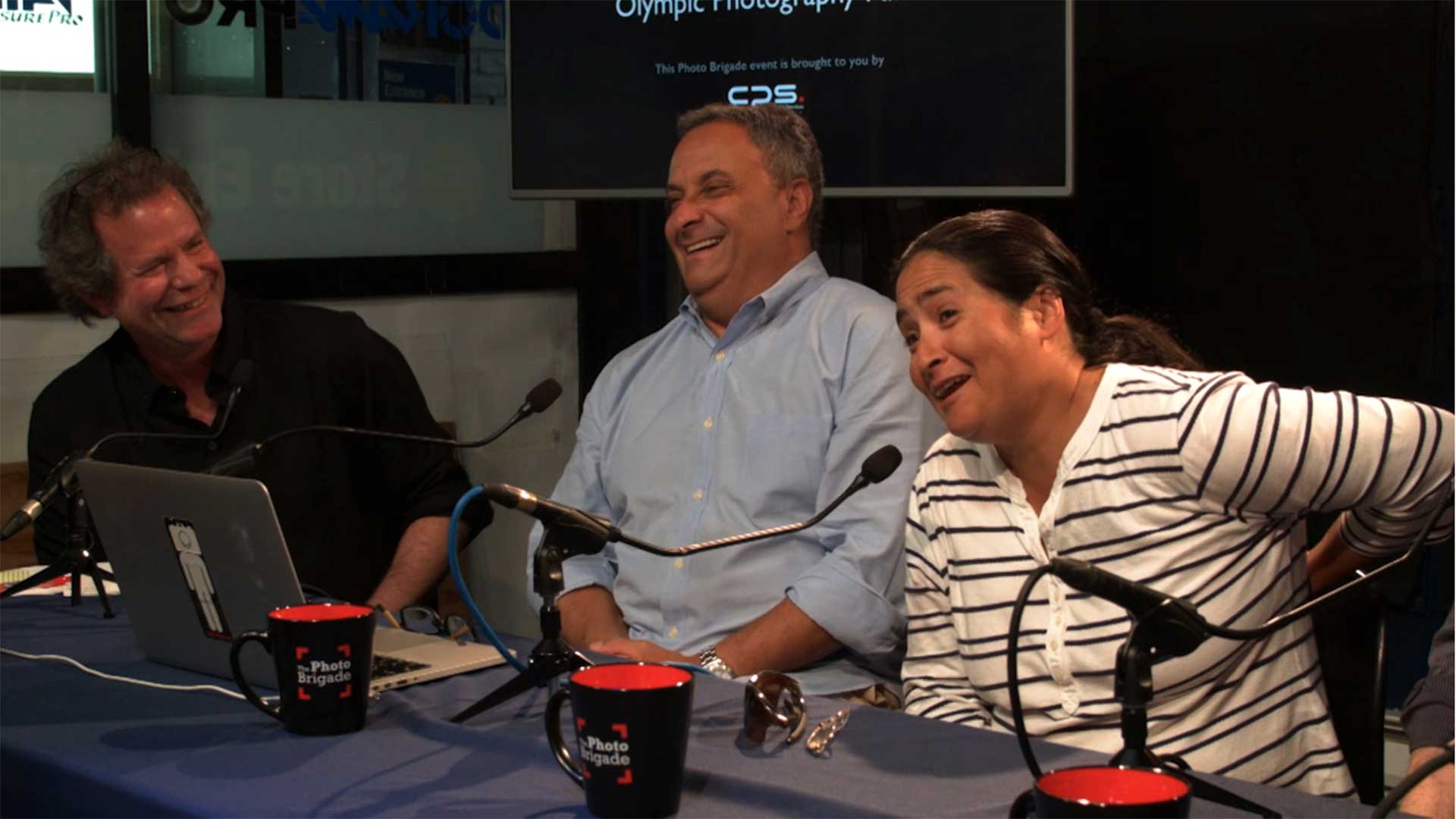 Steve Fine (far left) and Gary Hershorn share a laugh as Julie Jacobson recollects a humorous anecdote.