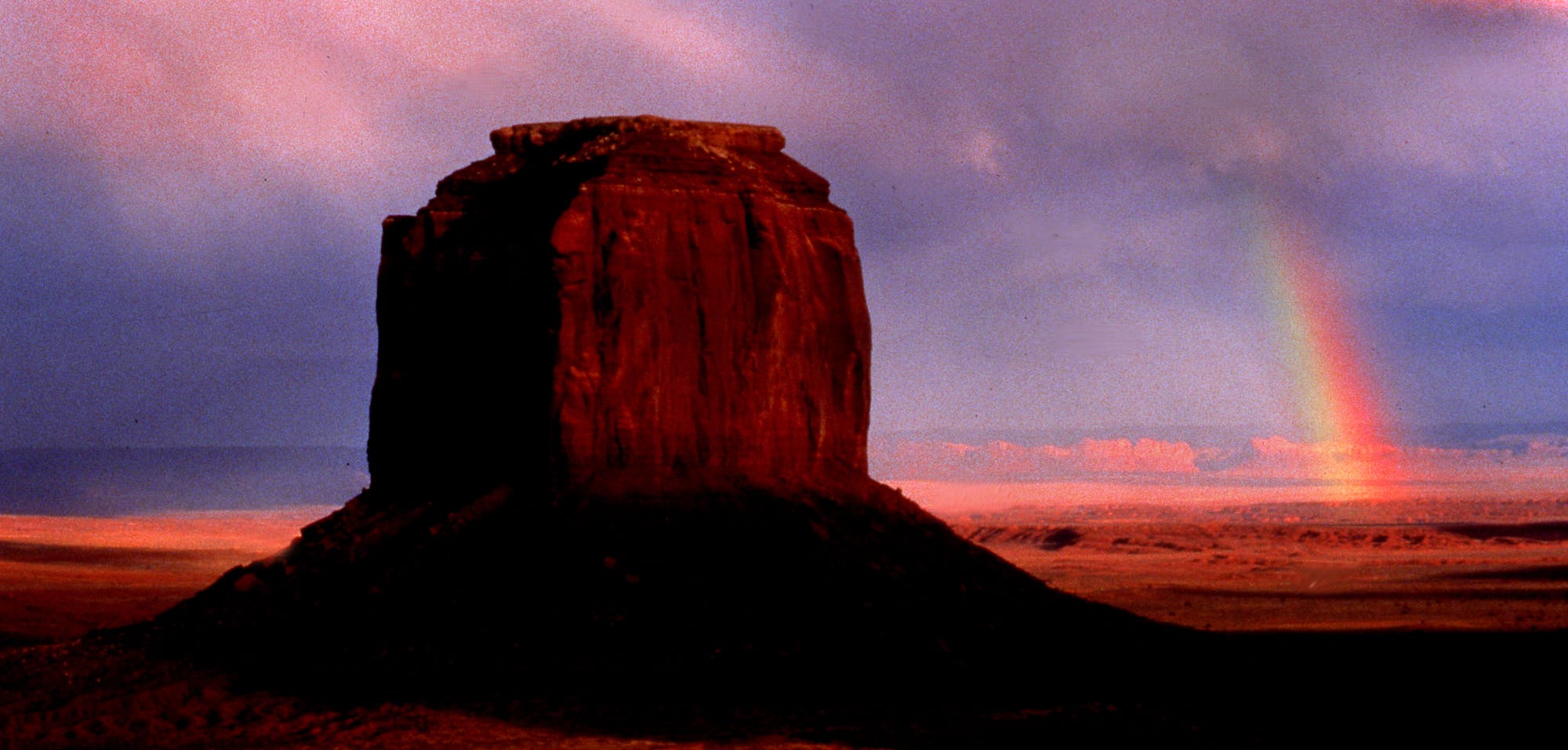 Thunderclouds swept over Monument Valley one late afternoon but our Navajo guide urged us to stick around despite the chance of rain. We watched as a downpour hit nearby (luckily we were spared) and then saw a fabulous rainbow in the distance where sunlight had returned. I found a vantage point that would show one of the buttes together with the rainbow, used a 300mm lens and polarized to concentrate the colors of the rainbow.