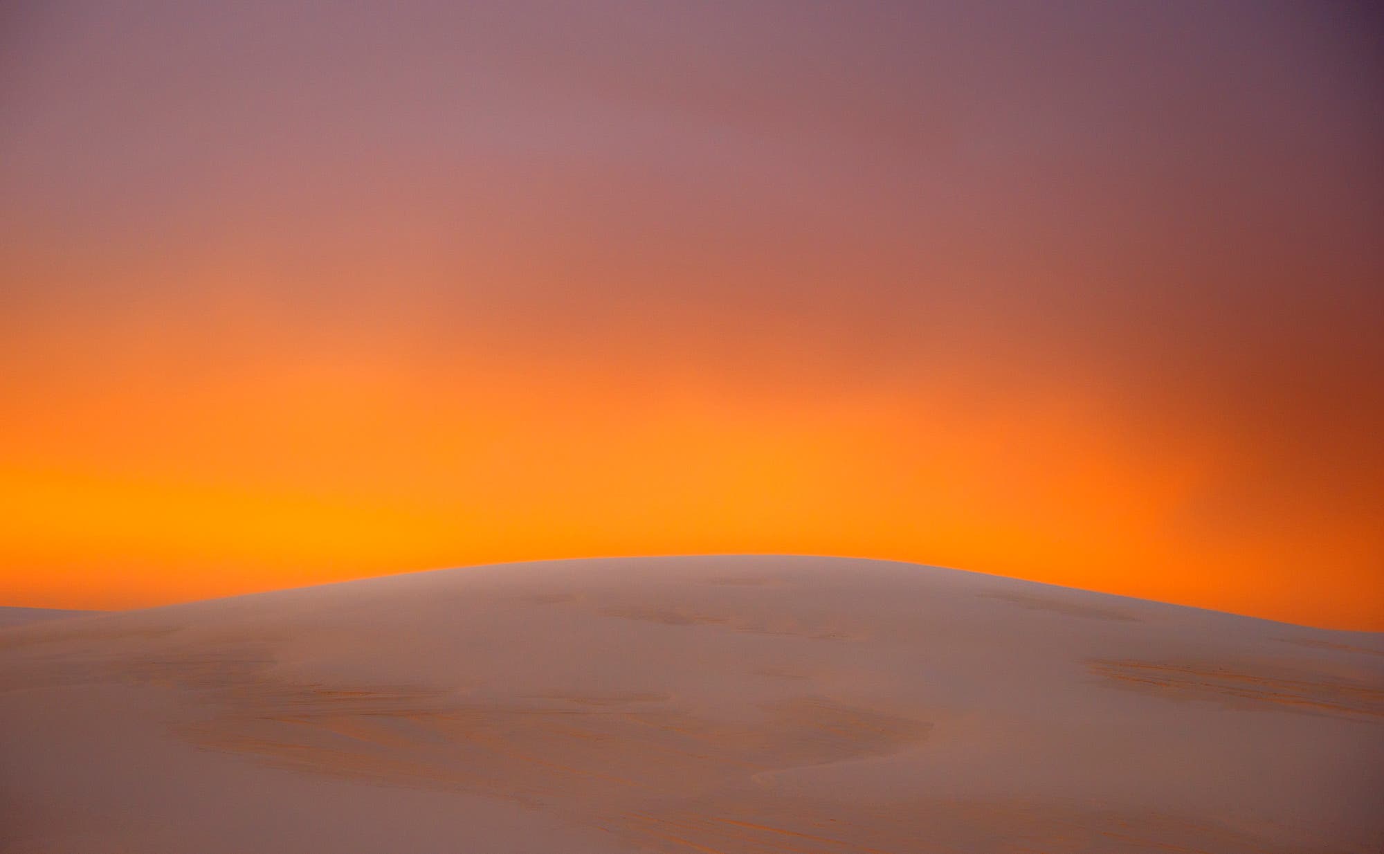 For this sunset image taken at White Sands National Monument, I was mainly interested in creating an abstract composition based on color. I was especially intrigued by the glow of light and chose a very simple dune for the foreground. I metered the sky, then overexposed by 1 1/2 stops to brighten the golden color. In after-capture, I reduced sharpness to soften the sand dune and finish with two bands of lush color.