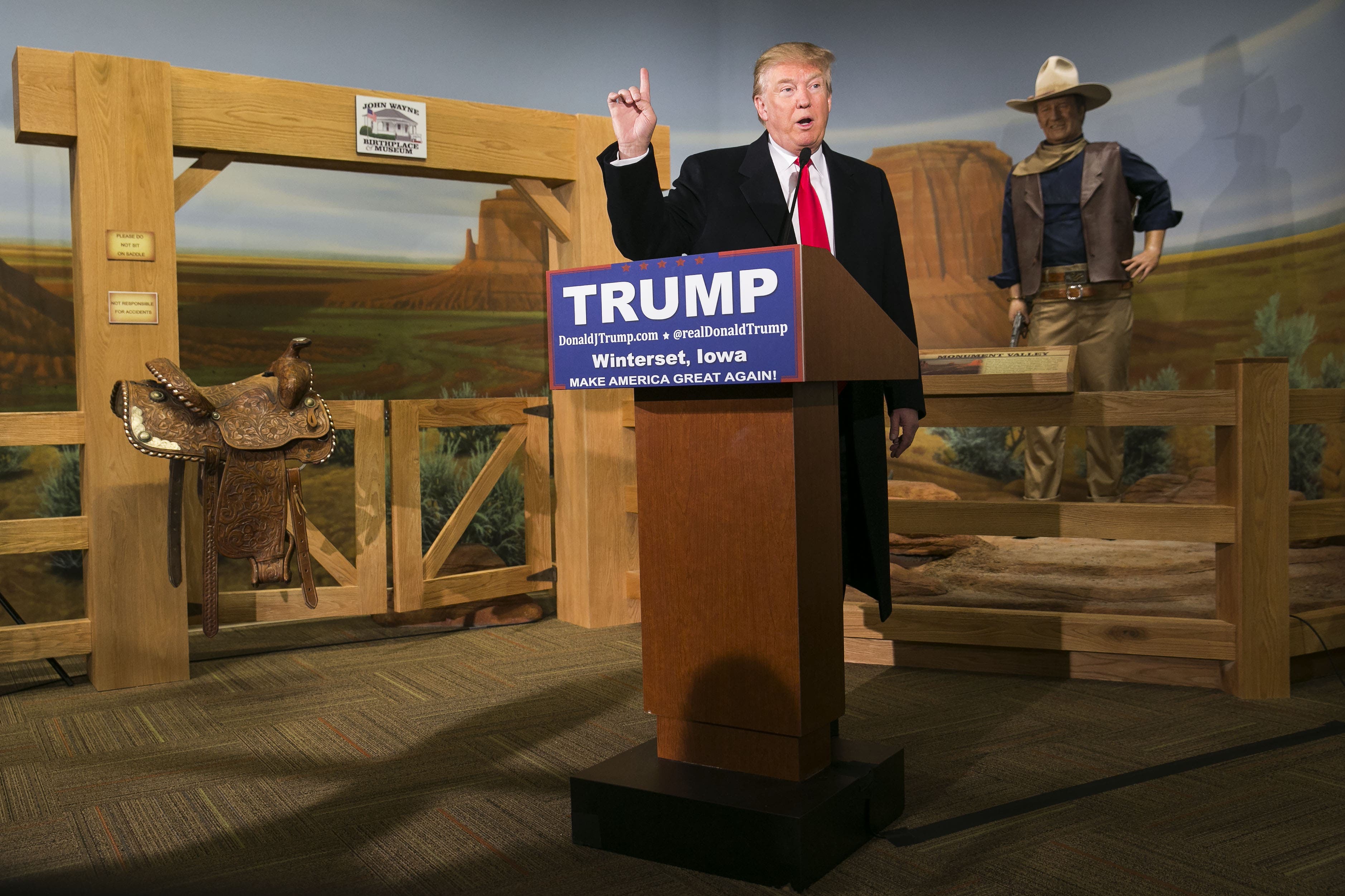 UNITED STATES - JANUARY 18 - A wax statue of John Wayne watches as Republican presidential candidate Donald Trump speaks during a news conference at the John Wayne Museum, Tuesday, Jan. 19, 2016, in Winterset, Iowa. (Photo By Al Drago/CQ Roll Call)
