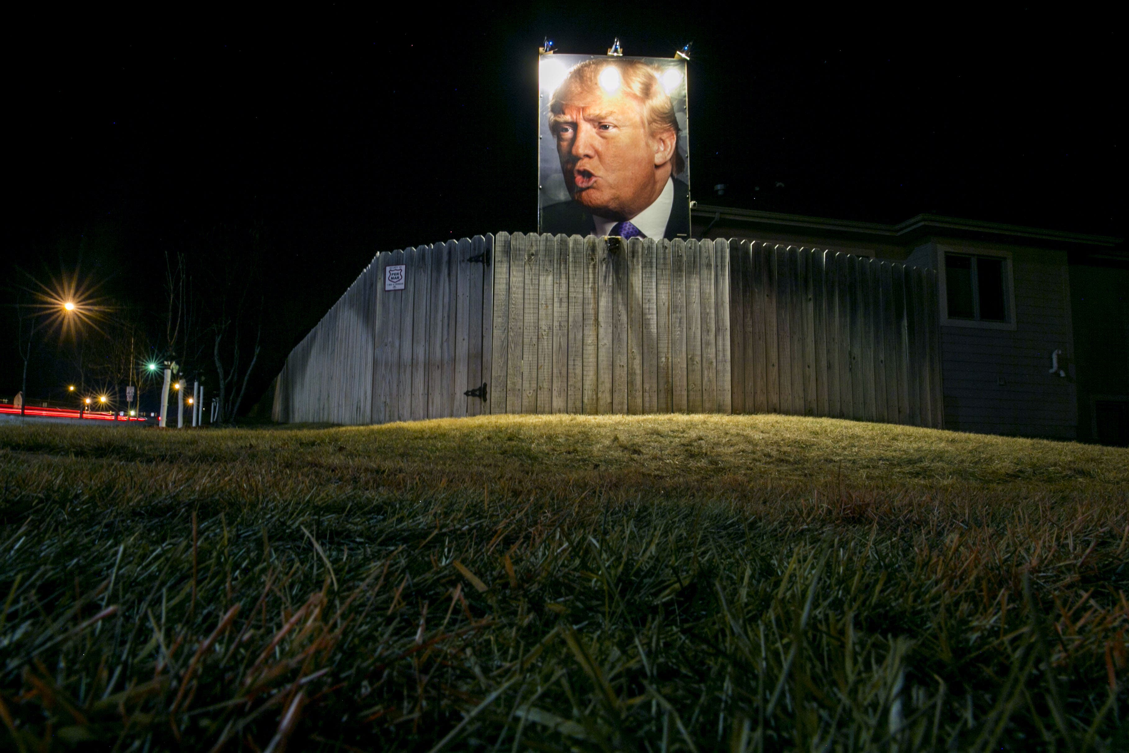 UNITED STATES - JANUARY 27 - In this long exposure photo, a giant poster of Republican presidential candidate Donald Trump stands on display in supporter George Davey's backyard in West Des Moines, Iowa, Wednesday, Jan. 27, 2016. (Photo By Al Drago/CQ Roll Call)
