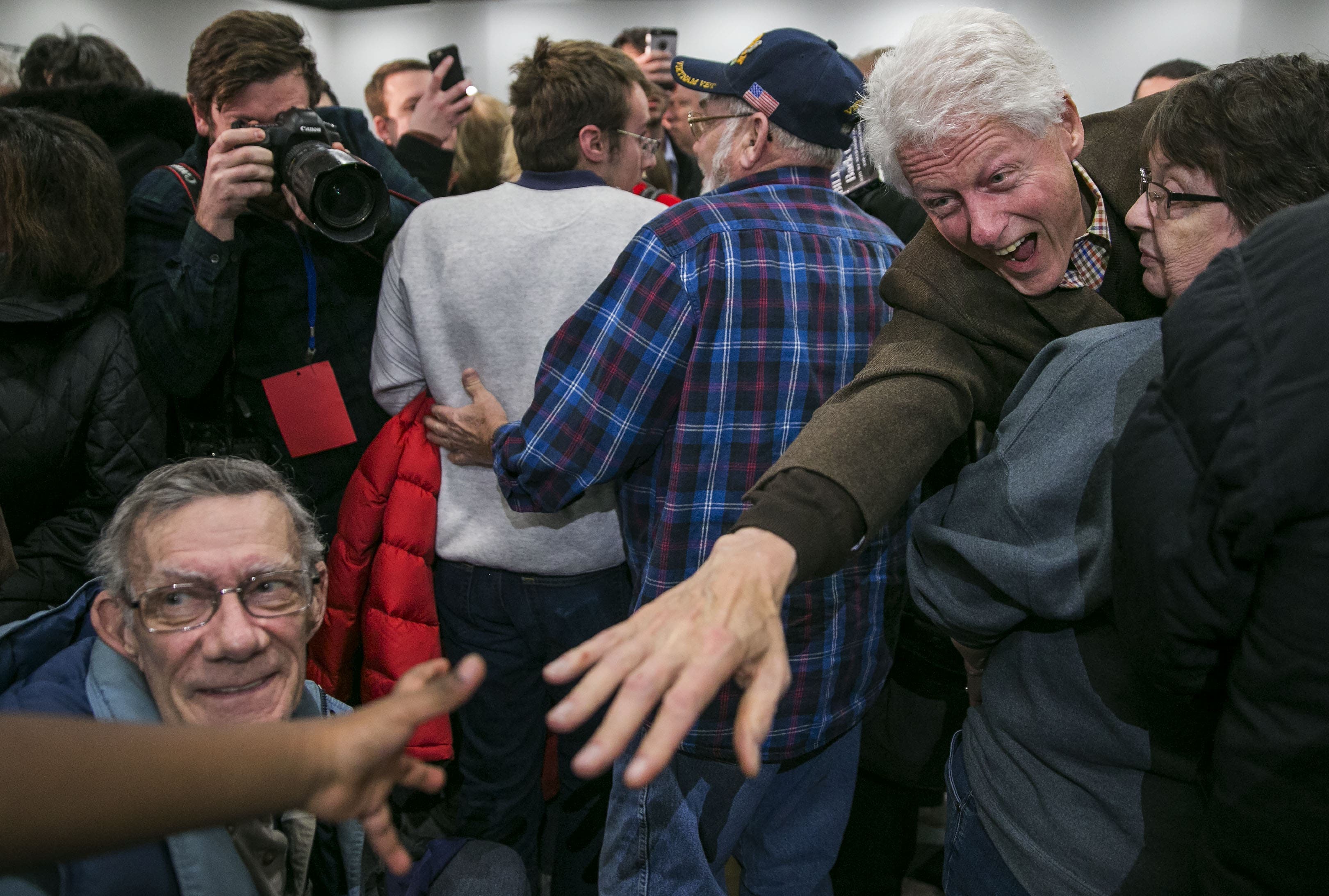 UNITED STATES - JANUARY 15 - Former President Bill Clinton reaches for a young boys hand that called out to him after a campaign event as he helps promote his wife, democratic presidential candidate Hillary Rodham Clinton, in Marshalltown, Iowa, on Friday, Jan. 15, 2016. (Photo By Al Drago/CQ Roll Call)