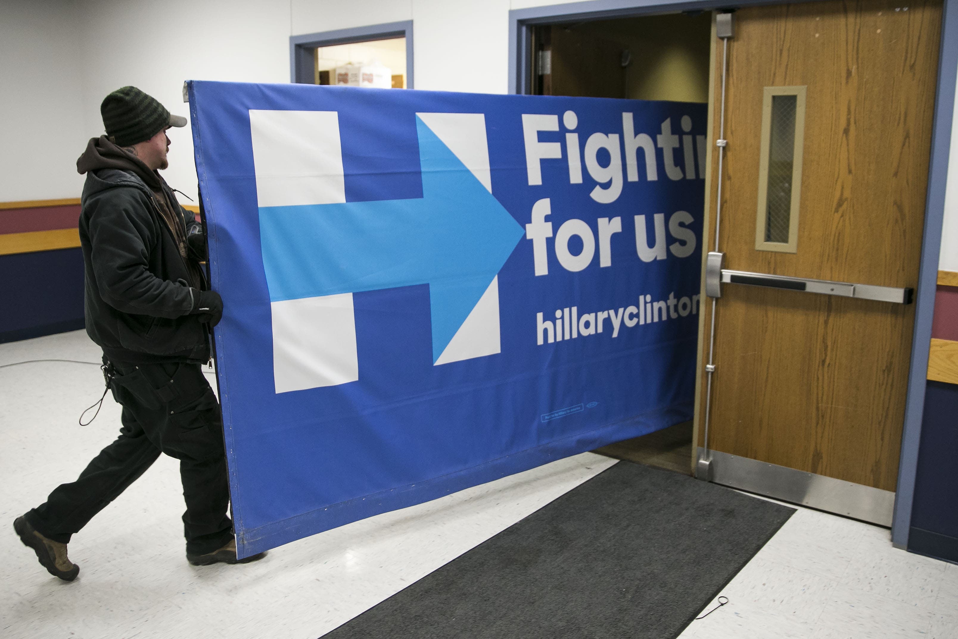 UNITED STATES - JANUARY 15 - Workers carry out a campaign sign for democratic presidential candidate Hillary Rodham Clinton, after a campaign event in Marshalltown, Iowa, on Friday, Jan. 15, 2016. (Photo By Al Drago/CQ Roll Call)
