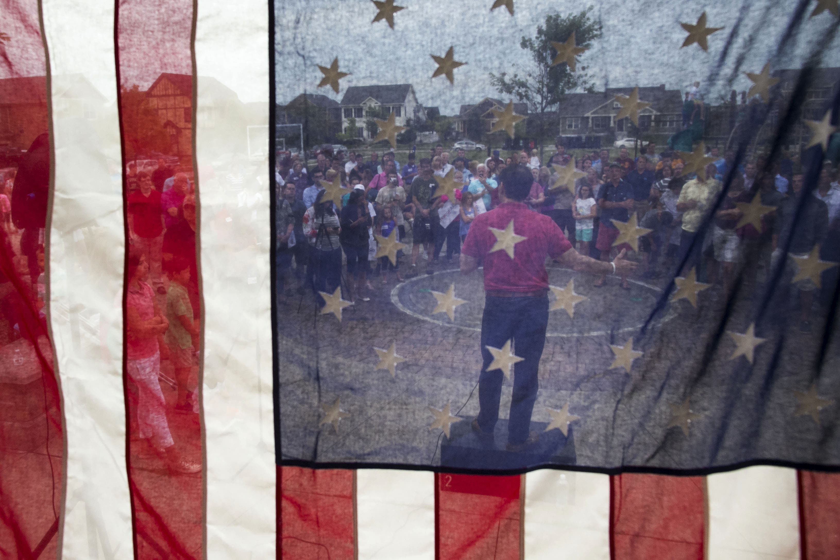 UNITED STATES - August 17: Republican presidential candidate Sen. Marco Rubio, R-Fla., speaks during a Family Night event at Dean Park, as seen from behind an American flag, in Ankeny, Iowa, Monday, August 17, 2015. (Photo By Al Drago/CQ Roll Call)