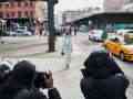 photographers and model on sidewalk in New York City during Fashion Week