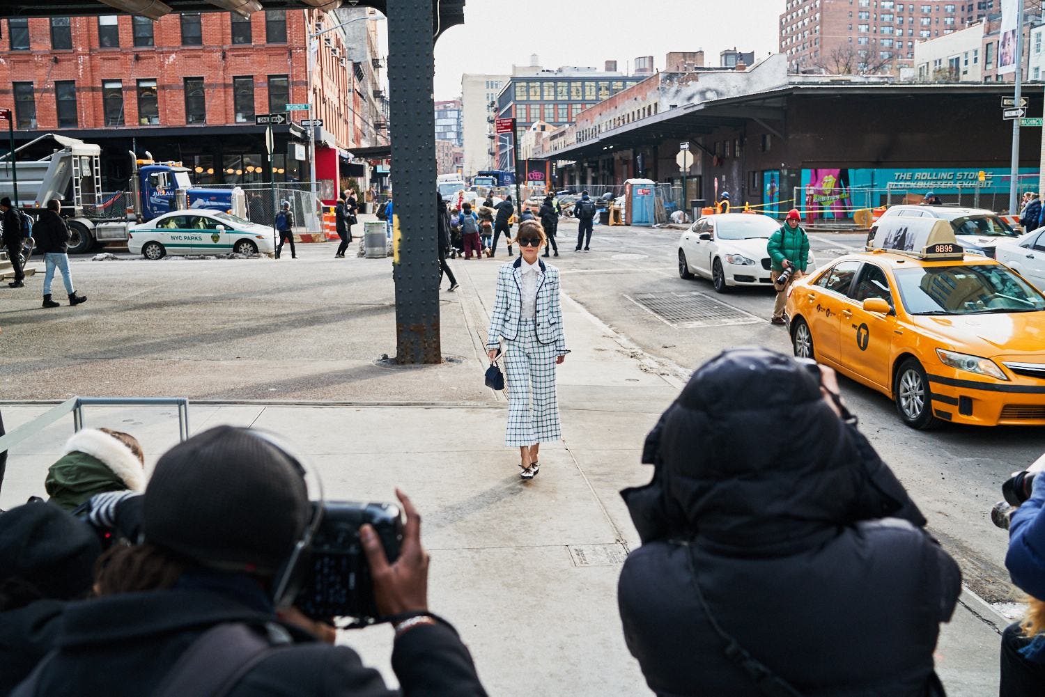 photographers and model on sidewalk in New York City during Fashion Week