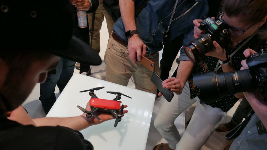 Attendees at DJI's #SeizetheMoment New York City Launch Event for the DJI Spark get up close with the mini drone in Lava Red. Photo by Liz Daza