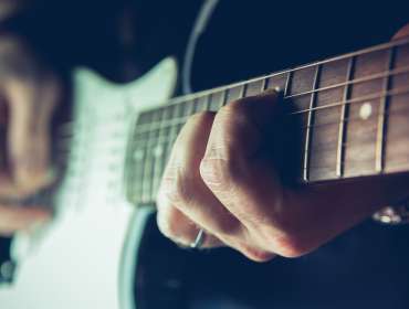 Young man playing electric guitar. Music, instrument education, entertainment, rock star, music concert and learning concept