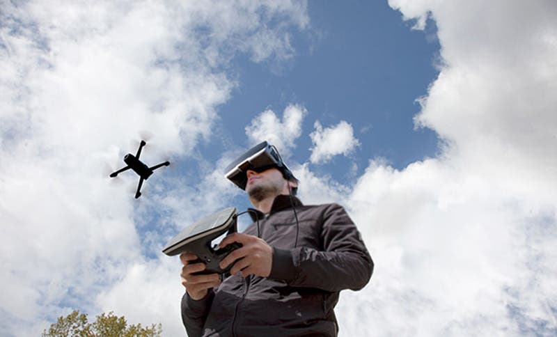 man using parrot bebop 2 drone with fpv glasses