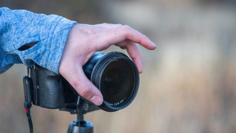 Austin adjusts a filter on his lens.