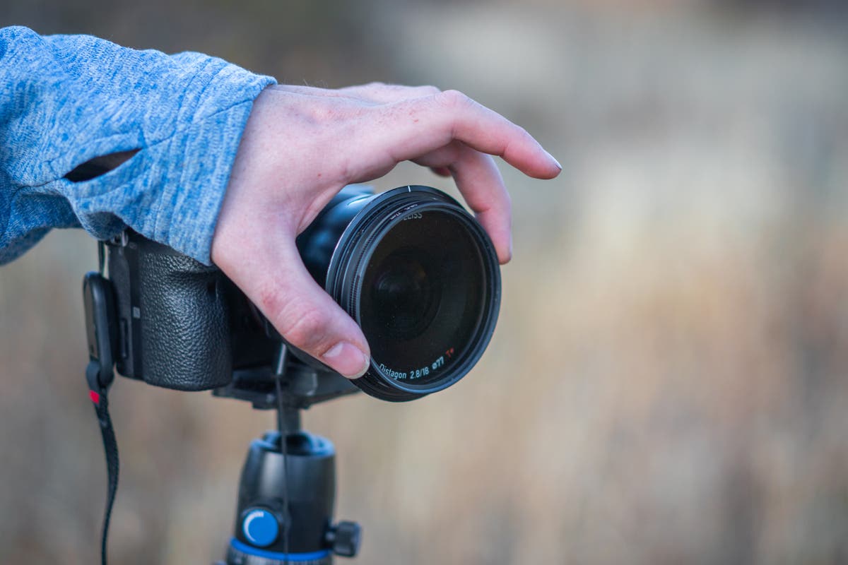 Austin adjusts a filter on his lens.