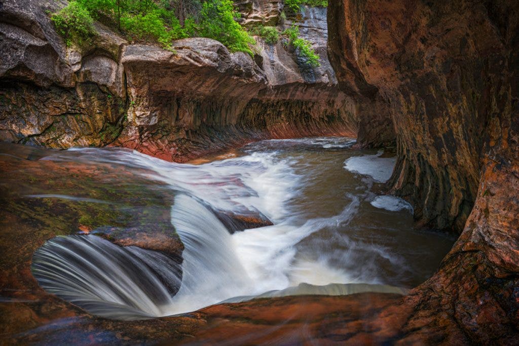 A polarizer helped to remove glare off the rocks and the water to show better colors in the image