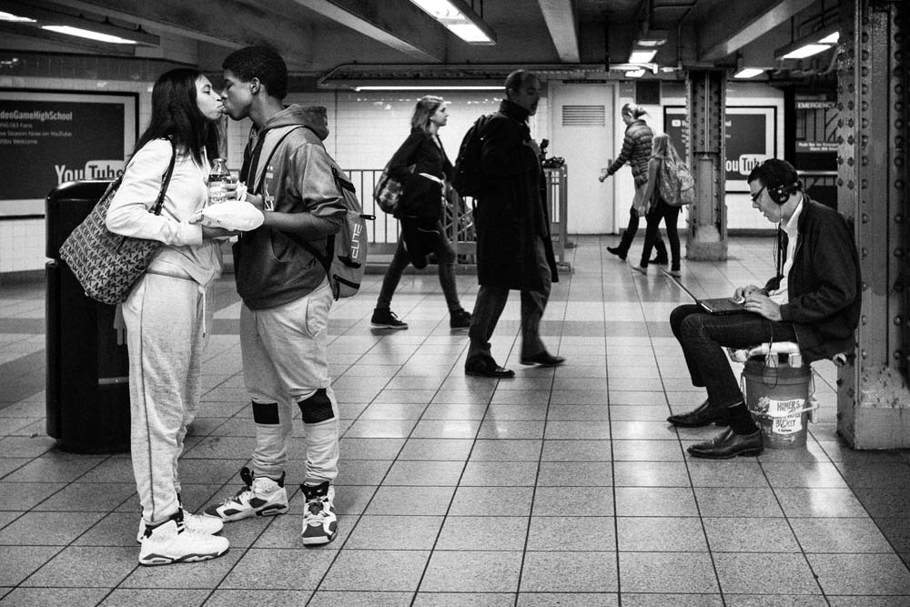 couple kissing in subway street photography Photo by Lauren Welles