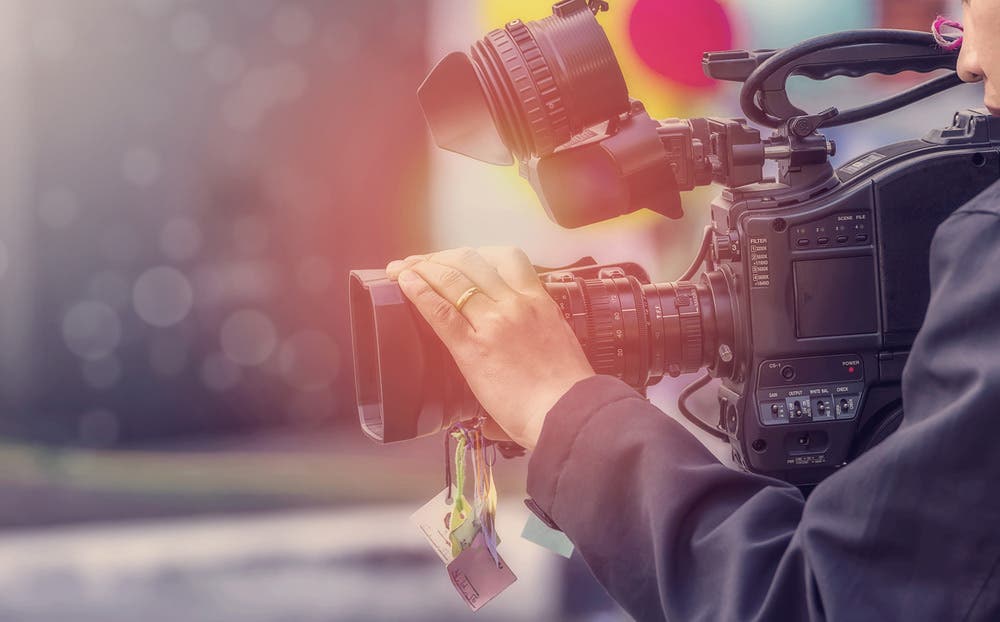 Artistic Filtered Shot of Videographer Using Cinema Lens