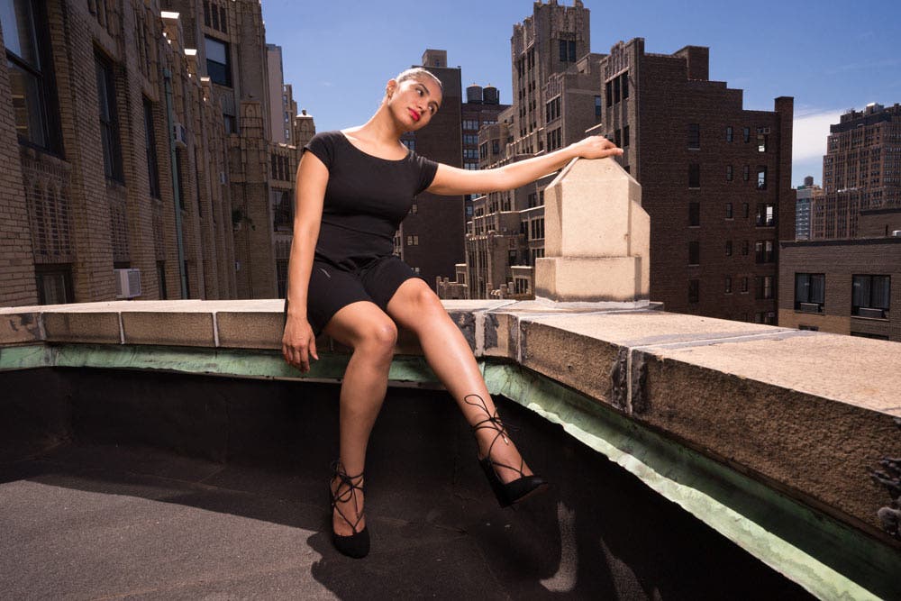 model wearing black dress at the balcony