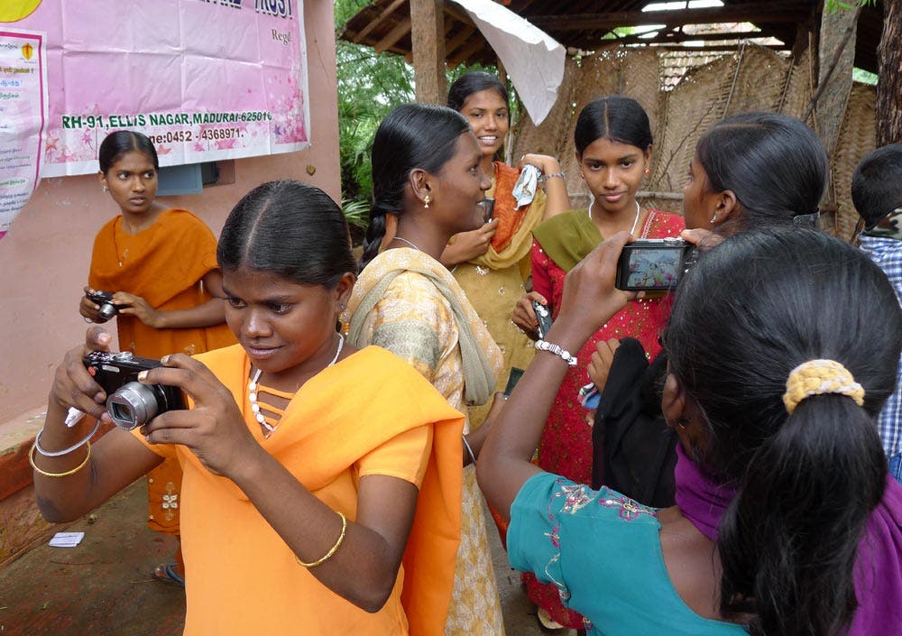 ethnic women using digital cameras
