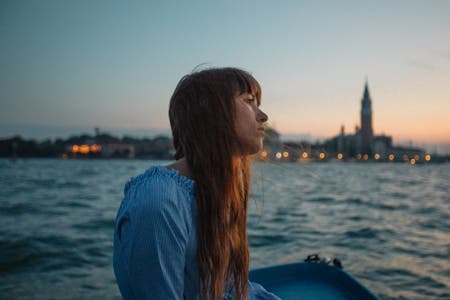 portrait of female sitting by the river travel photography