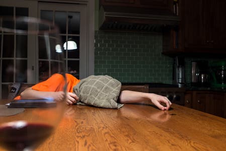 young boy lying on table with face covered