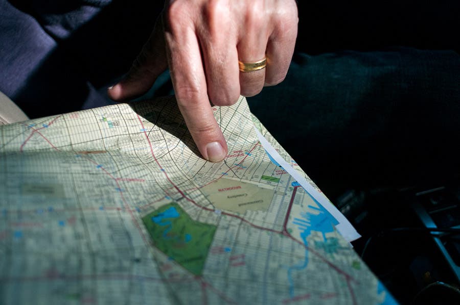 finger pointing at a spot on the map