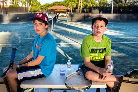 two boys at the tennis court