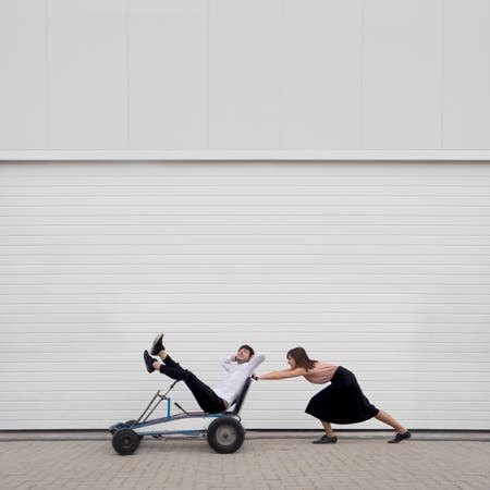 woman pushing man in a trolley