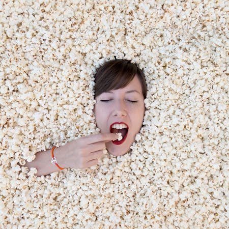 woman submerged in popcorn