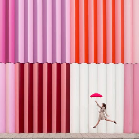 woman holding umbrella in front of colorful background