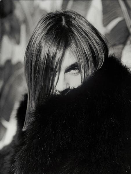 female model wearing black coat black and white portrait