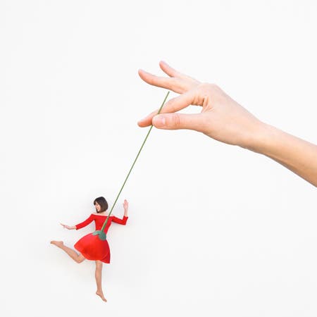 woman wearing a red dress with hand holding rose