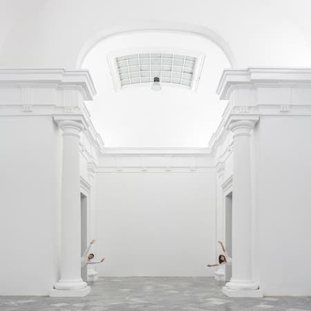 an and woman in white building with pillars