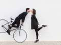 man on bicycle trying to kiss woman