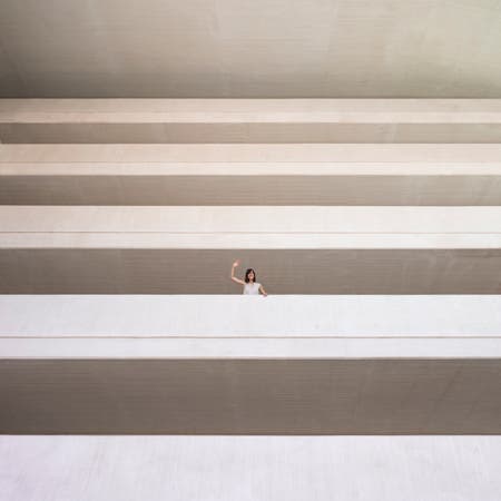 woman waving from building