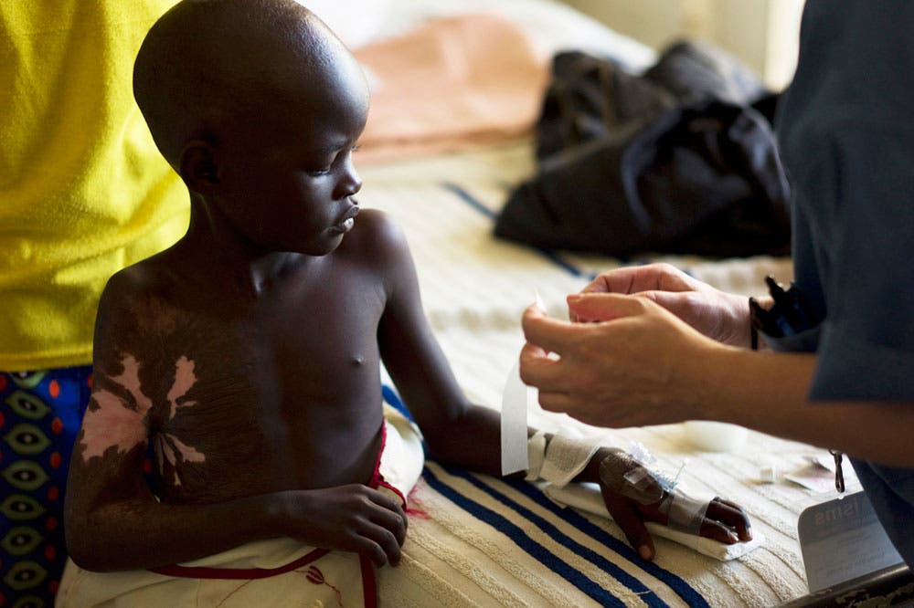 dextrose installation on young african boy