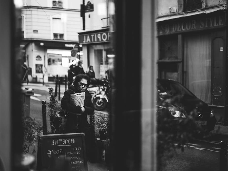 woman holding paper bag street photography