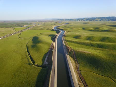 green fields along highway drone photography
