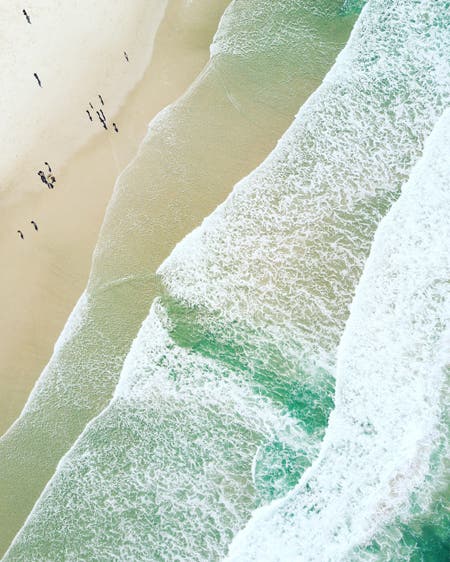 beach waves with people drone photography