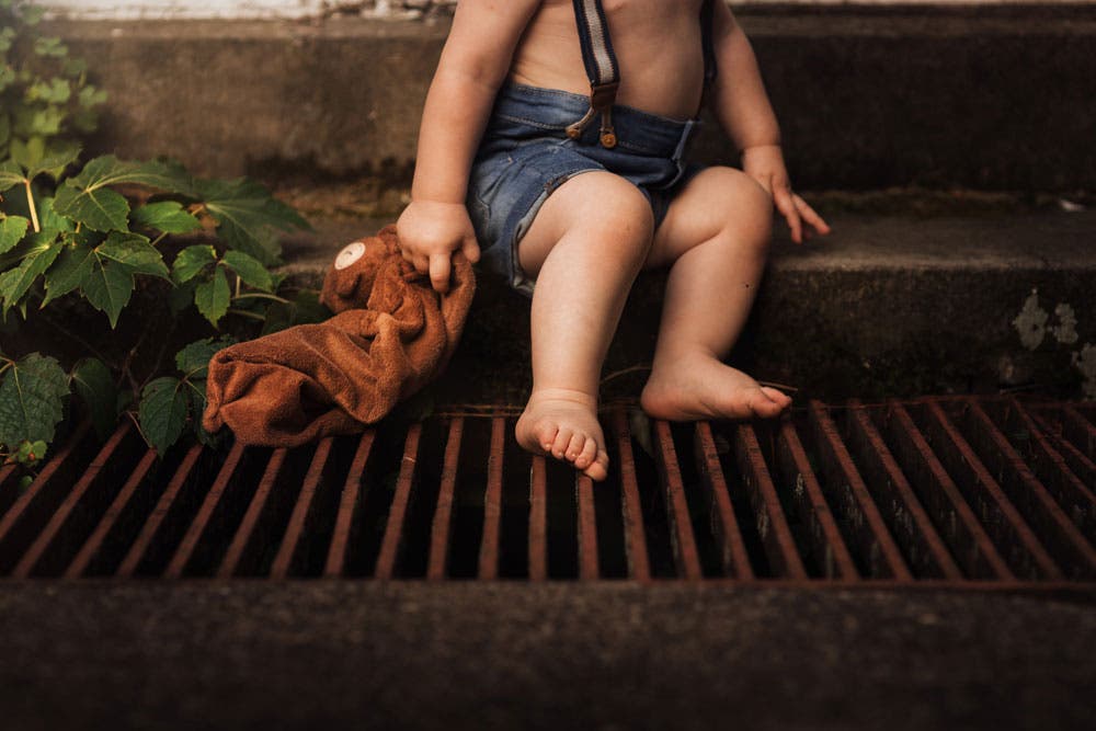 half portrait of boy wearing overalls