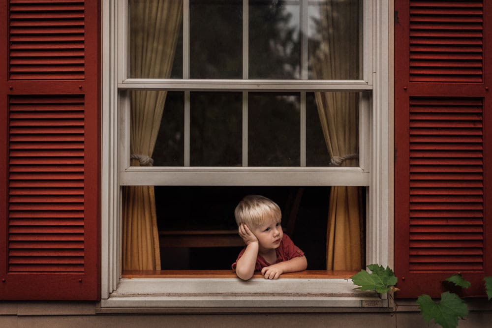 young boy looking out the window